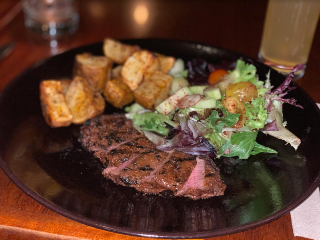 bison with roasted potatoes and salad