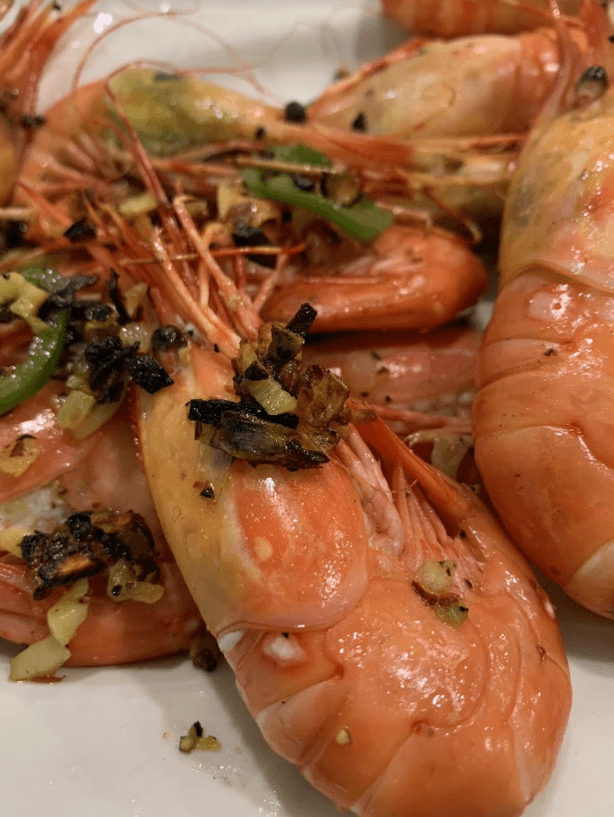 spot prawns with garlic butter on the side closeup view