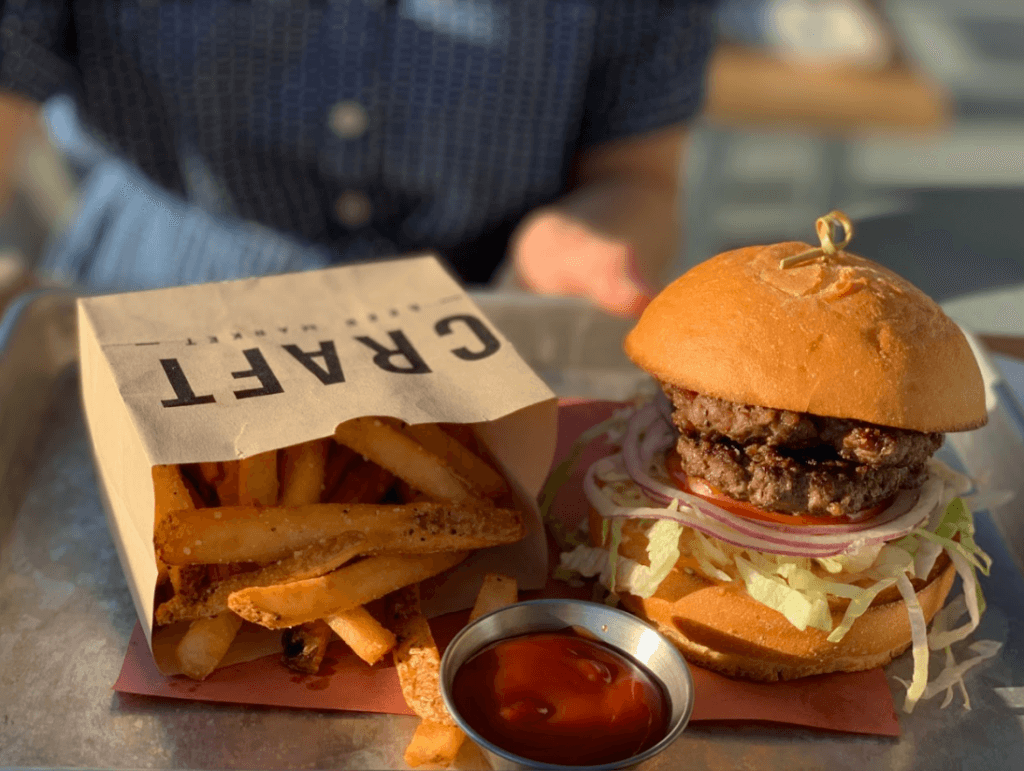 classic burger with a gluten free bun and fries