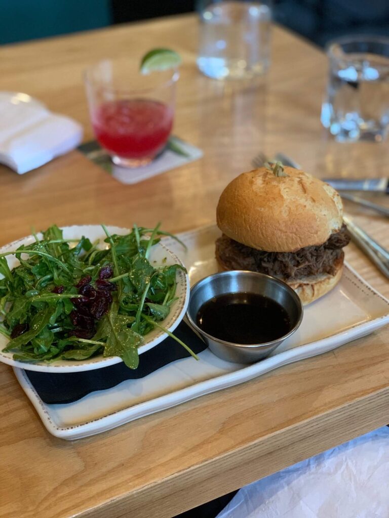 beef dip with a gluten free bun and a salad Stanley Park Brewing Restaurant & Brewpub