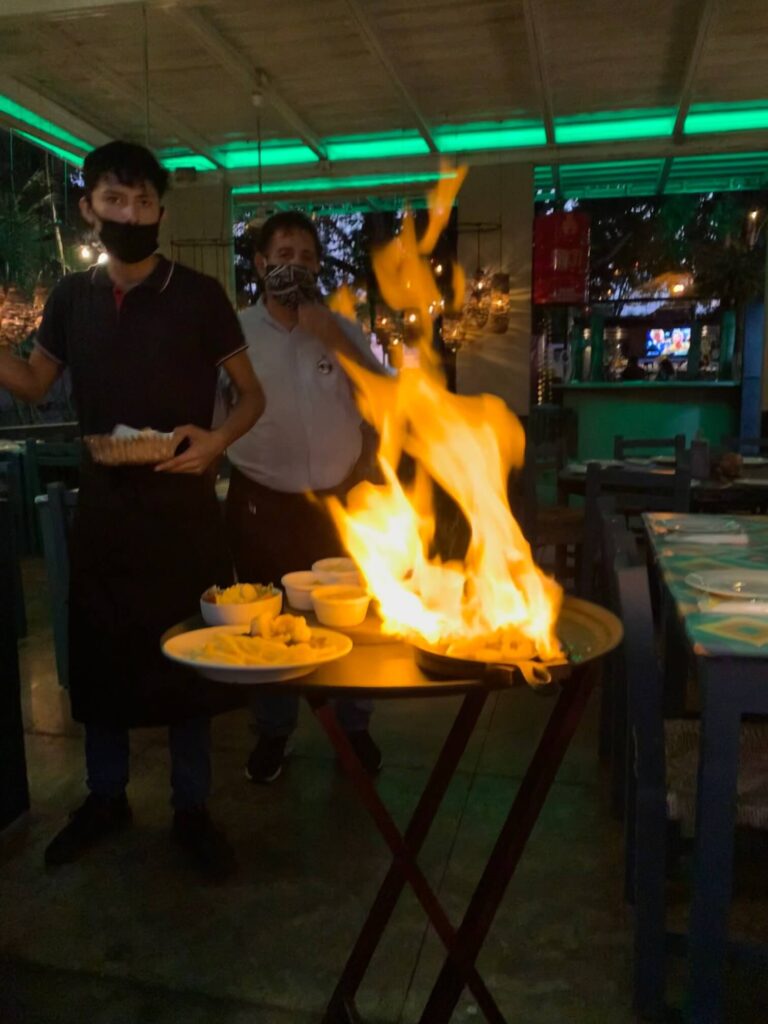 a person lighting fajitas on fire with tequila at fajita republic