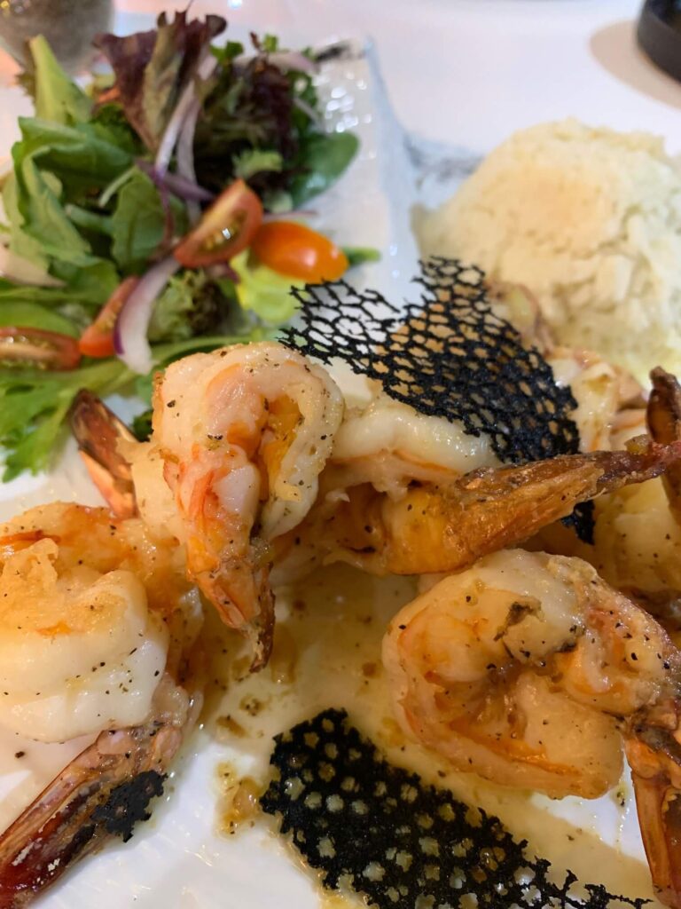 garlic shrimp with salad and rice closeup view