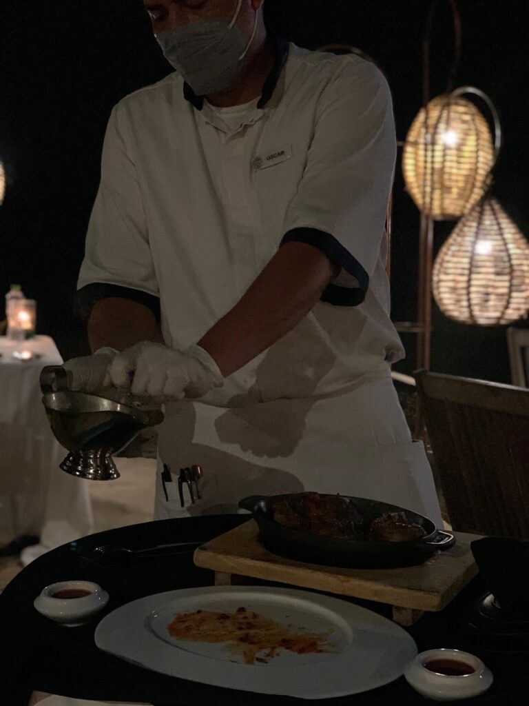 one of the cooks preparing our dish in front of us Tuna Blanco Punta Mita